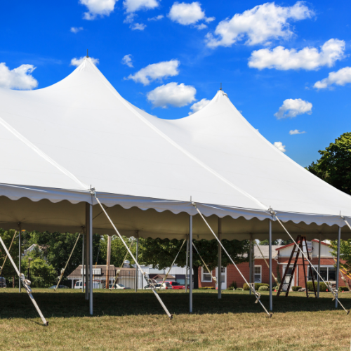 A white event tent setup outdoors.