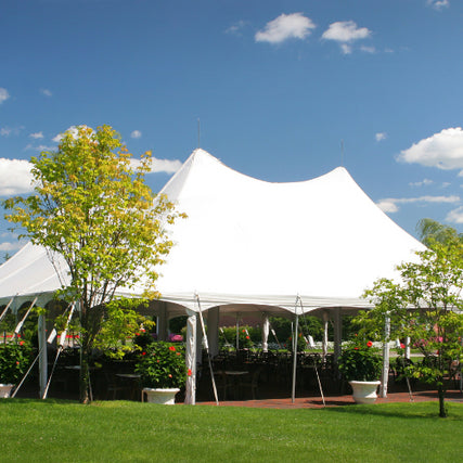 Tents & CanopiesA white event tent setup outdoors on a clear day.