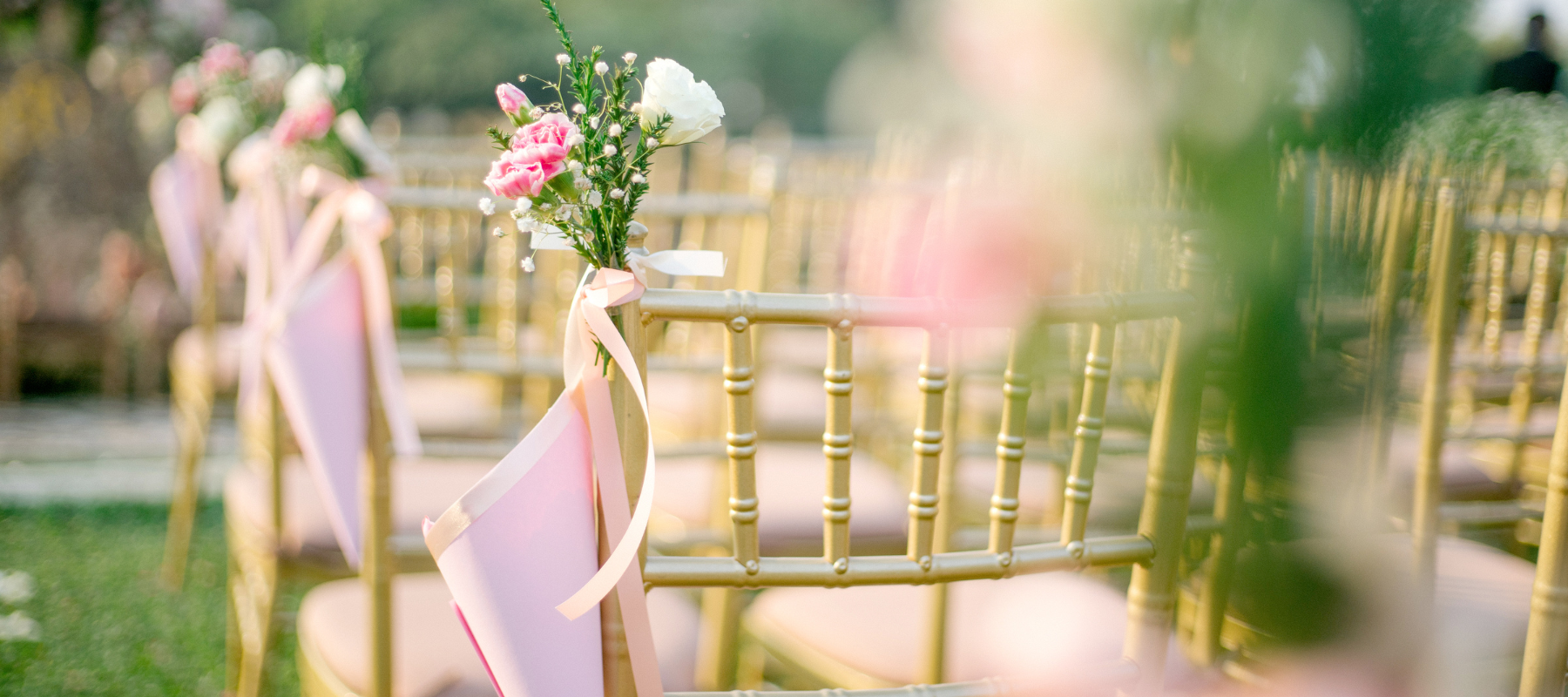 Wedding chairs staged and decorated with pink linens and flowers.